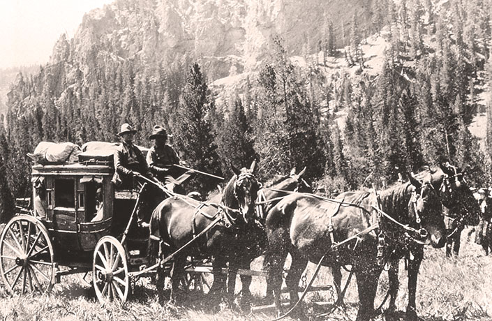 Stagecoach riders with shotguns for defense